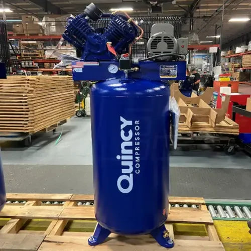 Quincy 60-Gallon Two-Stage Air Compressor (230V 1-Phase) - Mechanic Super Store shown in a warehouse on a pallet