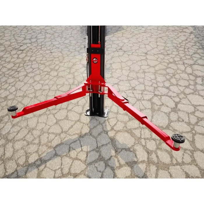 Katool KT-AS110D 11,000 lbs Asymmetrical 2 Post Lift support arm over a cracked asphalt driveway