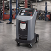 Robinair AC1234-4 Recover, Recycle, Recharge Machine showing in a mechanic shop with 2 and 4 post car lifts in the background.