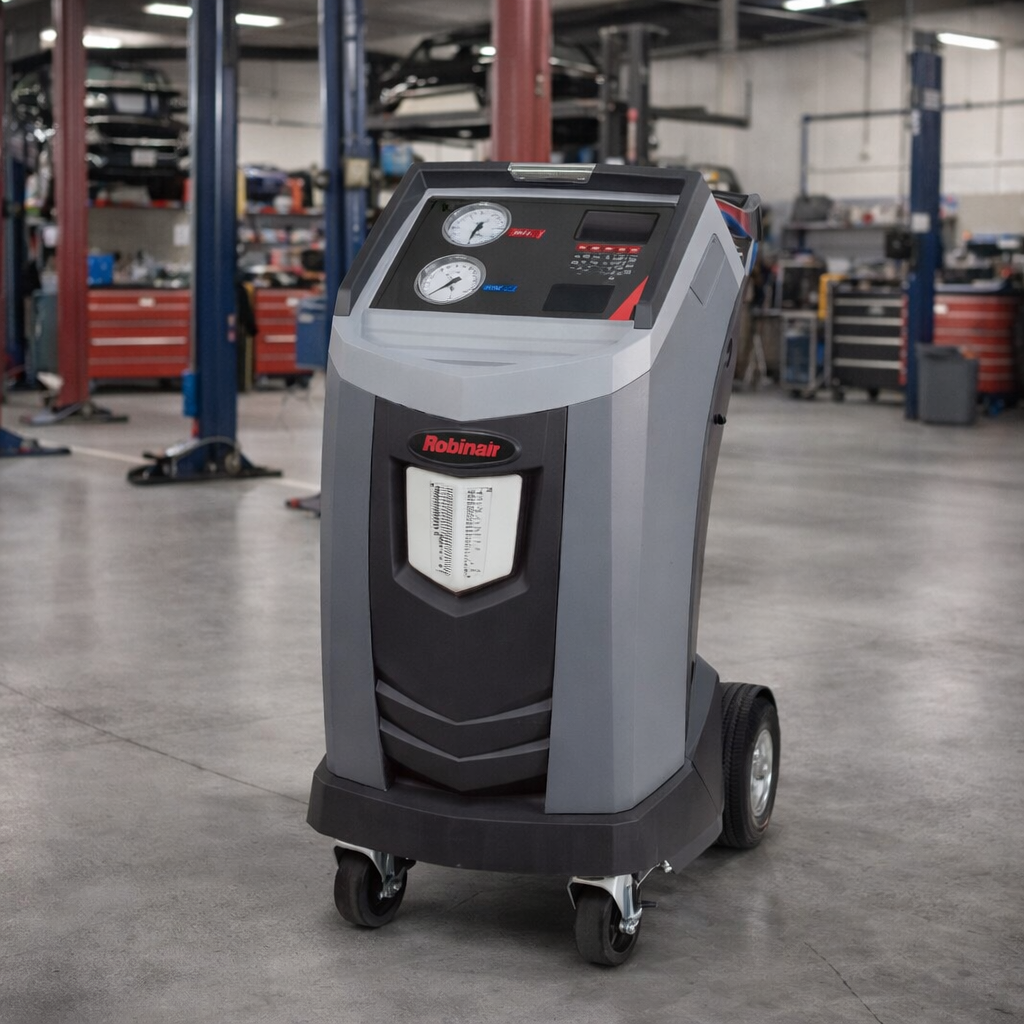 Robinair AC1234-4 Recover, Recycle, Recharge Machine showing in a mechanic shop with 2 and 4 post car lifts in the background.