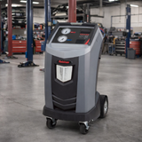 Robinair AC1234-4 Recover, Recycle, Recharge Machine showing in a mechanic shop with 2 and 4 post car lifts in the background.