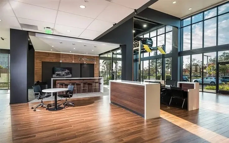 BendPak HD-7PXW 7,000 lb. 4 Post Lift shown in a luxury dealership - Mechanic Super Store