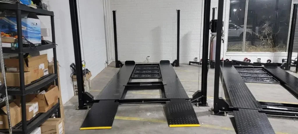 Tuxedo/Valor VP8K-DX 8,000 lb 4 Post Deluxe Storage Lift by mechanic superstore inside of a warehouse