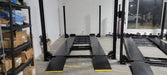 Tuxedo/Valor VP8K-DX 8,000 lb 4 Post Deluxe Storage Lift by mechanic superstore inside of a warehouse