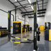 Supreme SP-10CFX 10,000 lb Clear Floor 2 Post Car Lift shown inside a yellow and black branded mechanic garage/shop